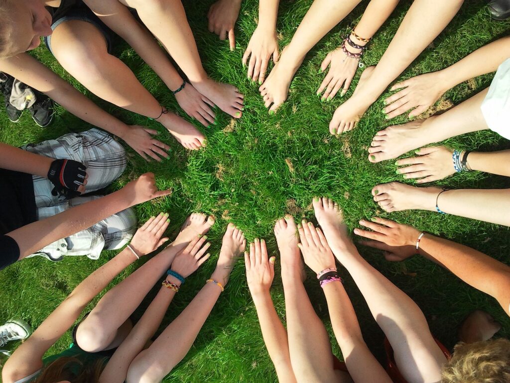 image of hands of various nationalities forming a huddle circle